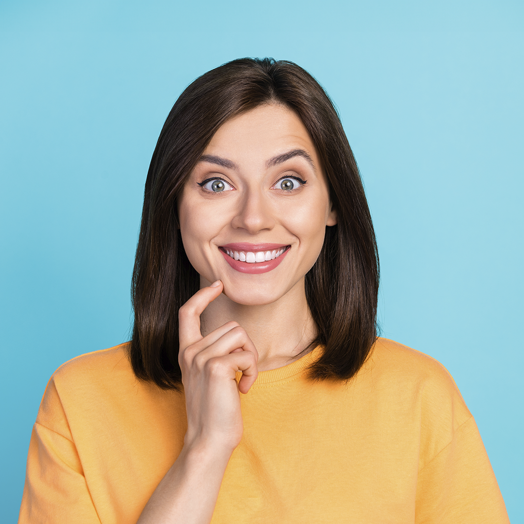A Young Woman Smiling Wide With All Her Upper Teeth Seen