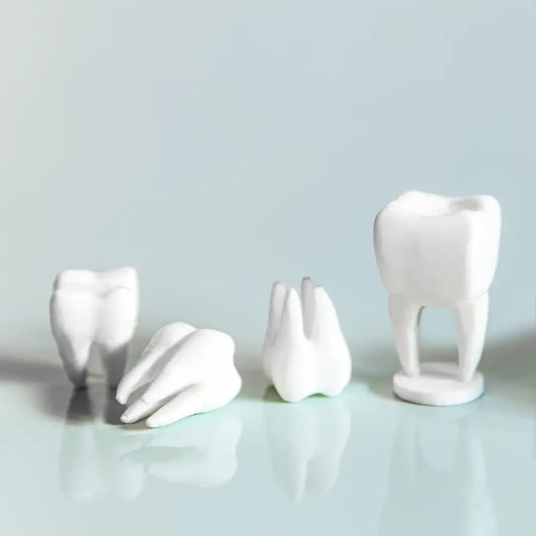 An Image Of Four Dental Crowns Placed On Table