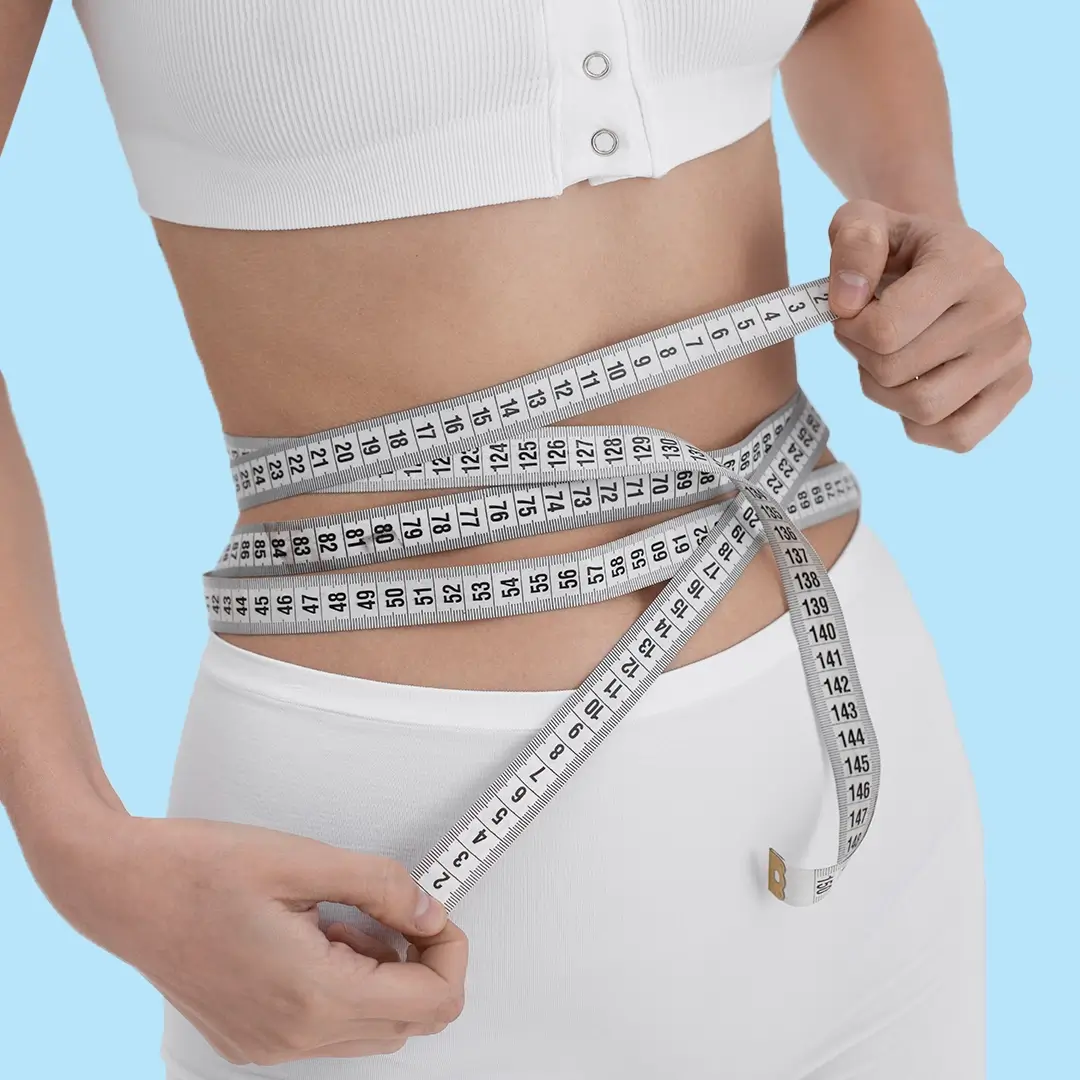 A Woman Holding A Measuring Tape Around Her Waist