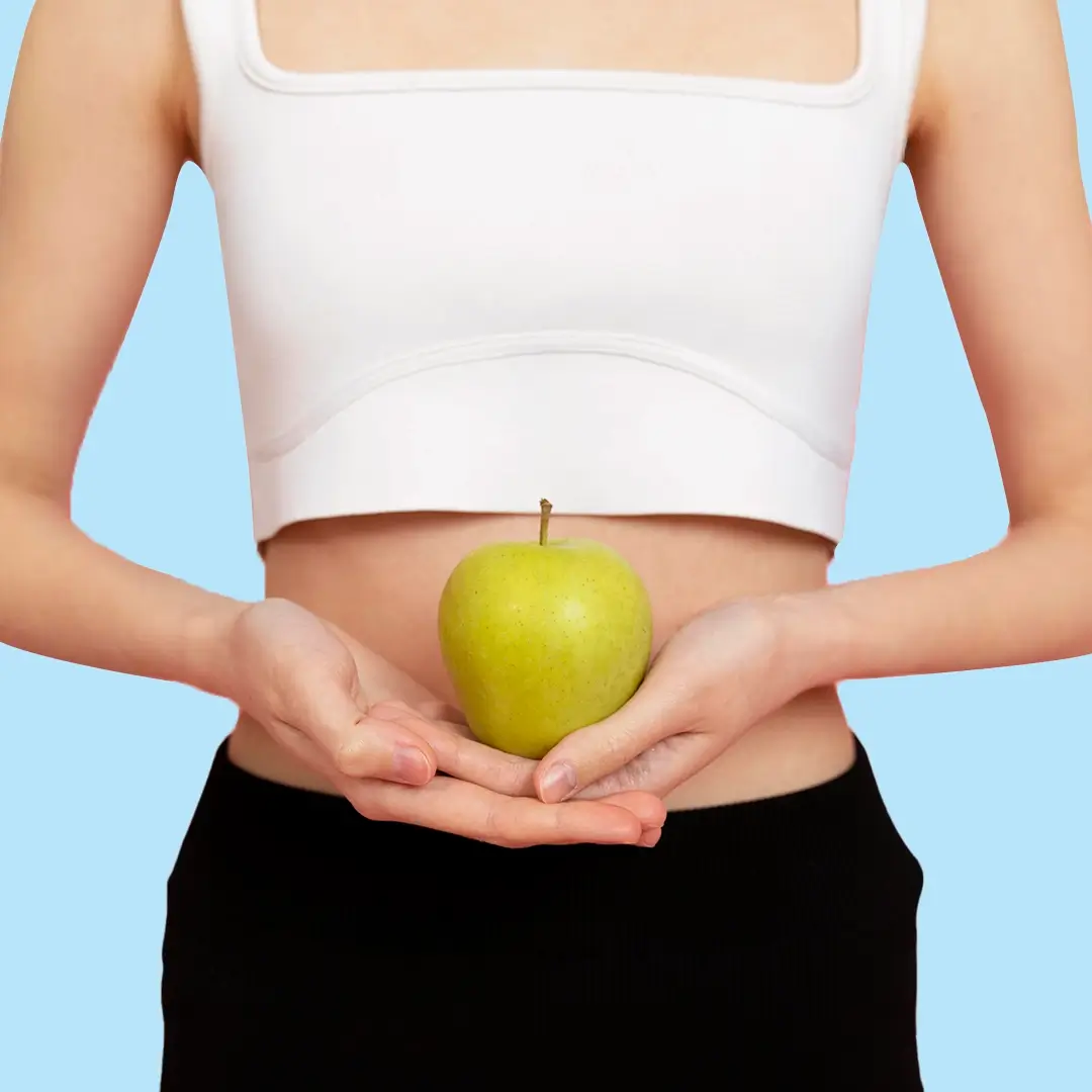 An Image Of Slim Woman Holding A Green Apple In Her Hands