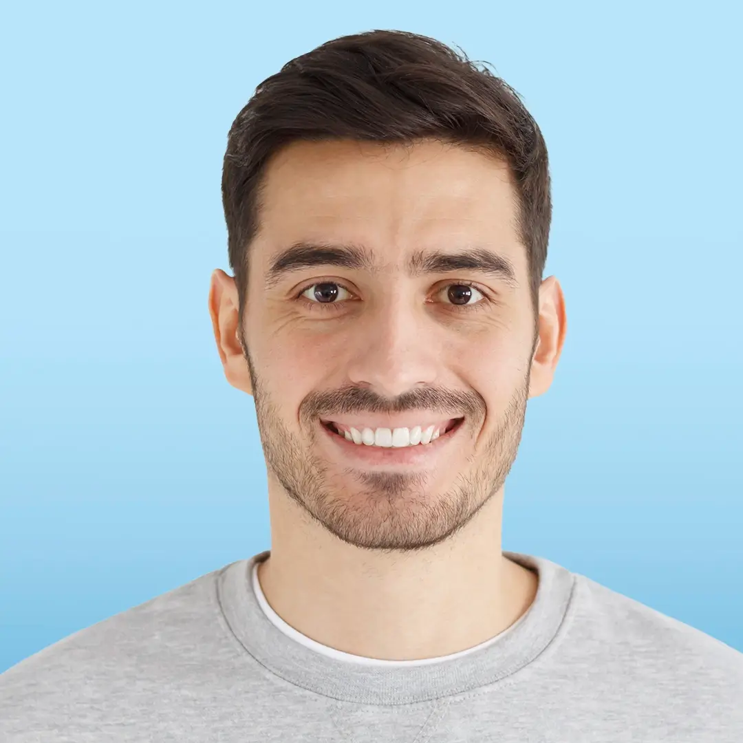 An Image Of A Portrait Of A Young Man Smiling With His Teeth Seen