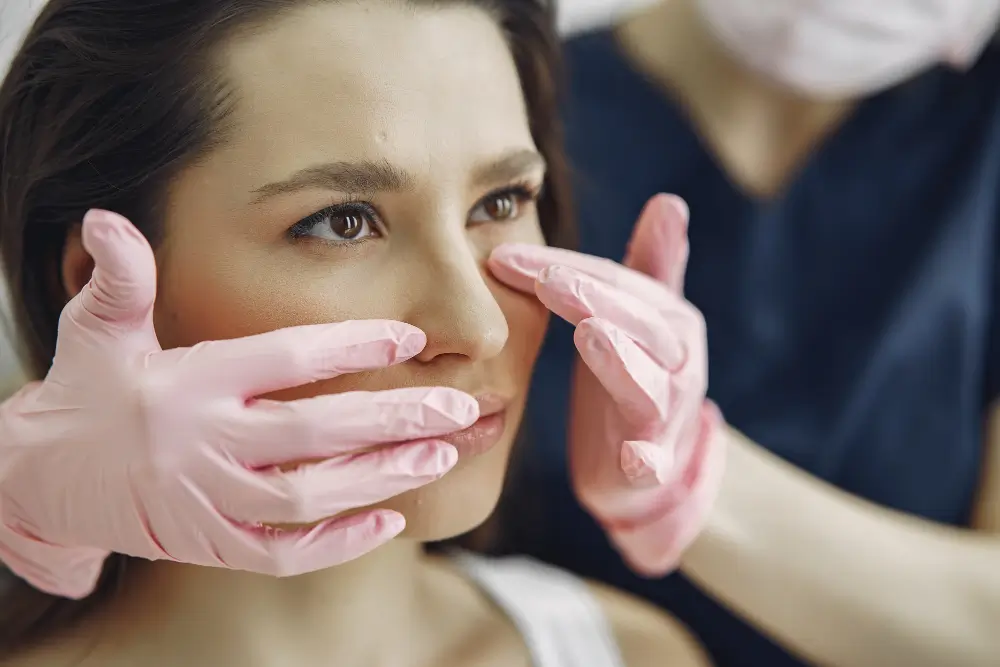 A Surgeon Examining Rhinoplasty Patient